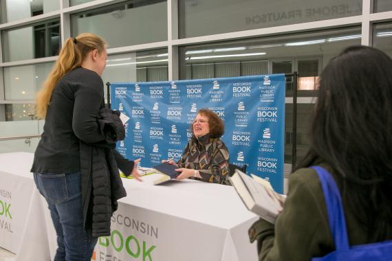 Author Amy Goldstein signing books at a WBF event