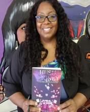 Photo of Jacquie Abrams holding a copy of Hush Money